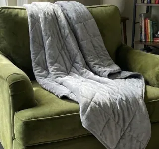 Velin Weighted Blanket spread across an armchair